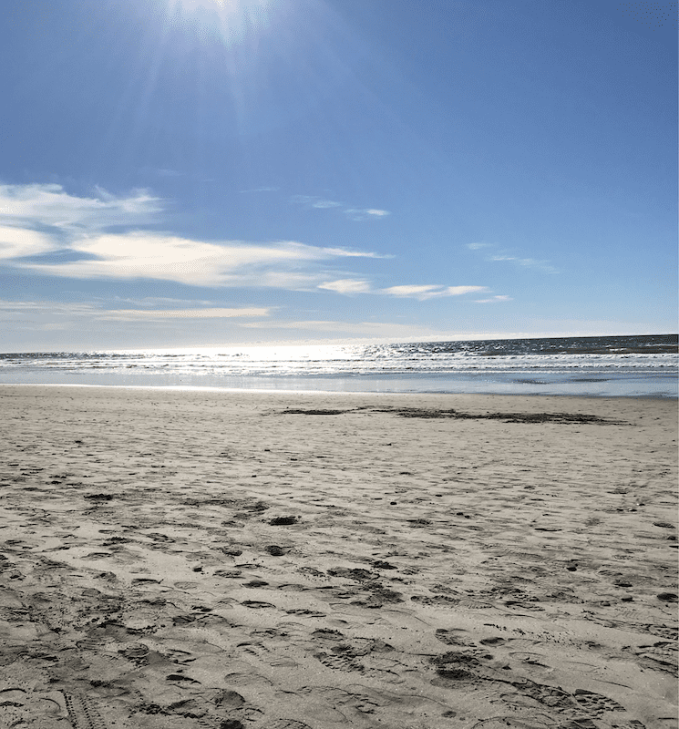Footprints on a beach on a sunny day