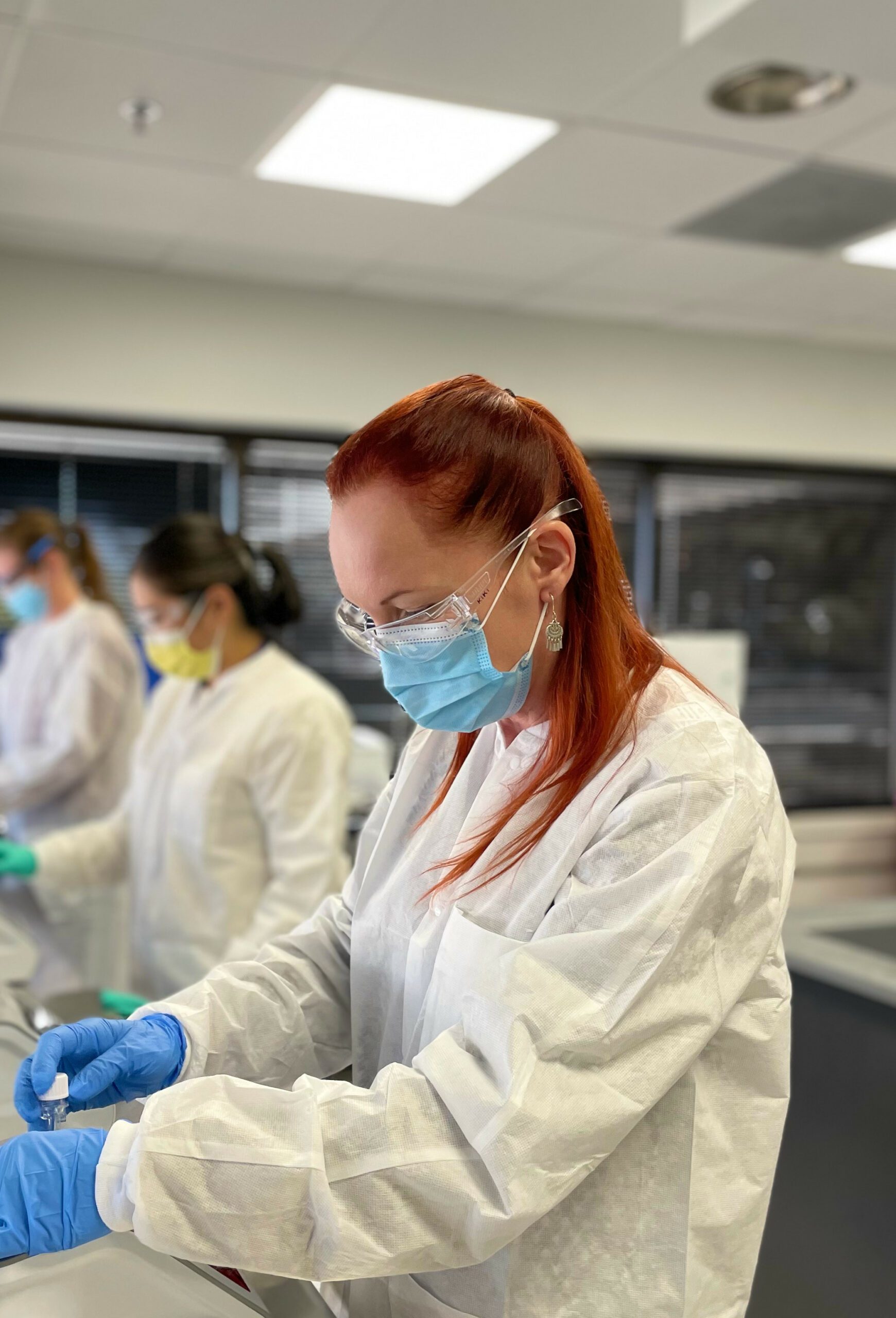 Kiki Bromann in a lab wearing a lab gown